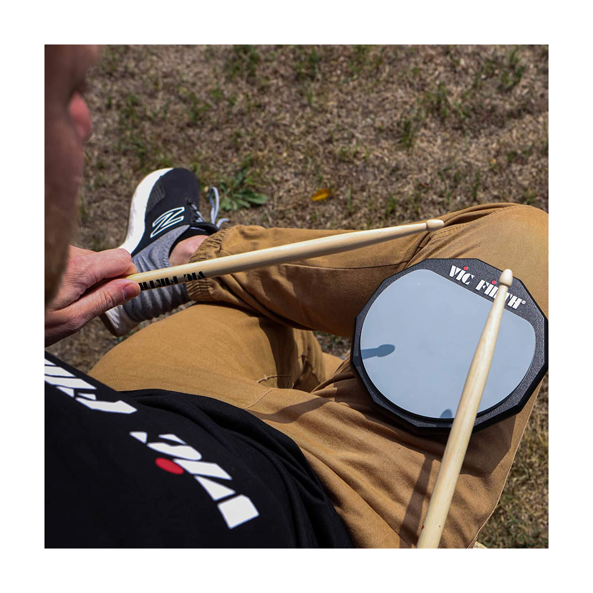 A person using the Vic Firth VFPAD6 Single Sided Practice Pad - 6 inch