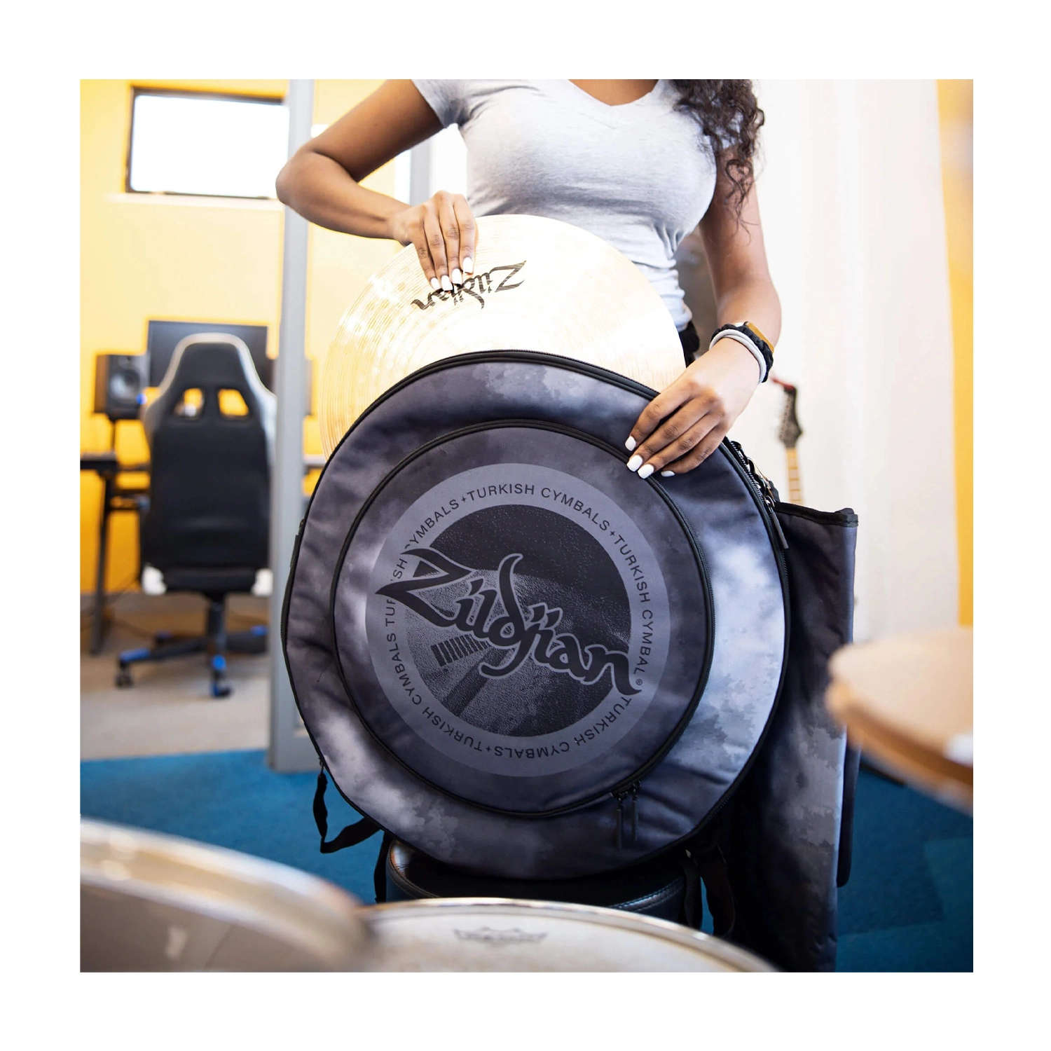 ZXCB00220 Lifestyle, Drummer getting ready for practice session.